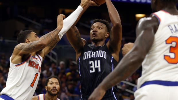 Oct 22, 2021; Orlando, Florida, USA; Orlando Magic center Wendell Carter Jr. (34) shoots as New York Knicks forward Obi Toppin (1) defends during the second half at Amway Center. Mandatory Credit: Kim Klement-USA TODAY Sports